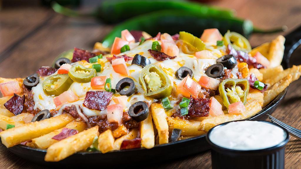 Extreme Loaded Texas Fries · Cheddar, Monterey Jack, bacon, jalapeños, scallions and ranch dressing drizzle.