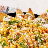 Mexican Street Corn Nachos · Corn, mayo, cotija, cayenne, lime seasoning, nachos and a creamy melted monterey jack cheese...