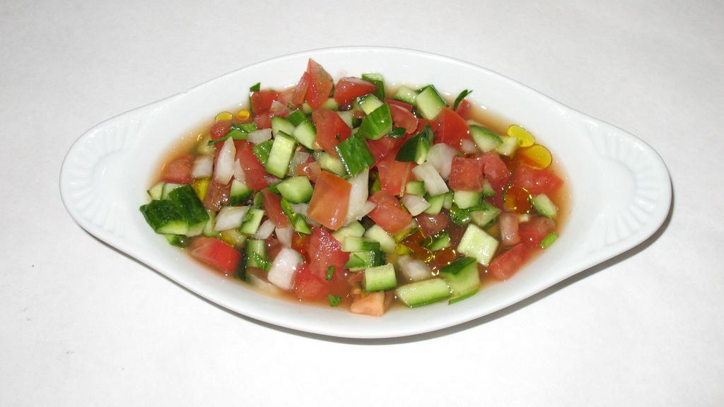Salad Shirazi! · Mixed diced tomatoes, cucumbers, onions, herbs and olive oil dressing.