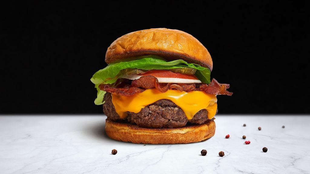 Bangin' Bacon Burger · The ultimate flavor: crispy bacon with a beef patty, lettuce, tomato, onion, and pickles.