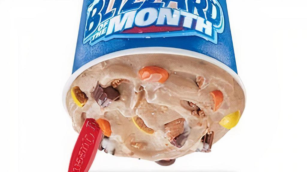 Reese'S Extreme Blizzard  · Reese's Peanut Butter Cups, Reese's Pieces, peanut butter topping and chocolatey topping blended with world famous soft serve to Blizzard perfection