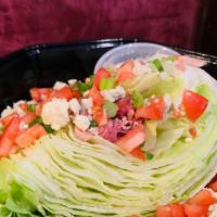 Wedge Salad · Iceberg lettuce, green onion, tomato, bacon, bleu cheese crumble, bleu cheese dressing