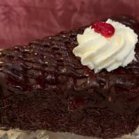 Raspberry Chocolate Cake Wedge · Chocolate chiffon cake layers filled with chocolate mousse, covered in raspberry chocolate g...