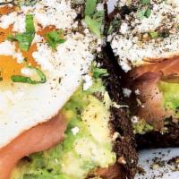 Toast Royale · Smashed avocado, smoked salmon, organic sunny side up eggs, feta, basil, and microgreens.