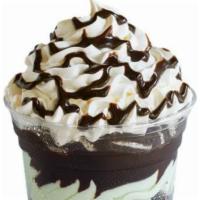 Mint Oreo Sundae Dasher ( Layered Ice Cream Sundae ) · Layers of oreo cookies mint ice cream and fudge topped with whipped cream and fudge drizzle.
