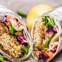 Falafel Wrap · Made with deep-fried chickpea patties, lettuce, tomato, pickles, onions, and garlic sauce. V...