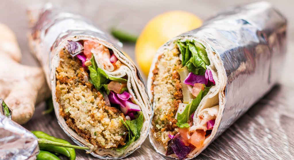 Falafel Wrap · Made with deep-fried chickpea patties, lettuce, tomato, pickles, onions, and garlic sauce. Vegetarian. Vegan.