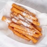 Funnel Cake Fries · Funnel cake fries topped with powdered sugar.