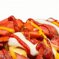 Salchipapa · French fríes with a hot dog and salad