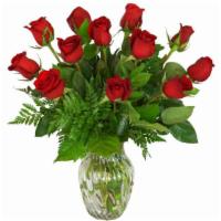 One Dozen Classic Red Roses · One dozen classic red roses, designed in a ginger vase and finished with foliage.