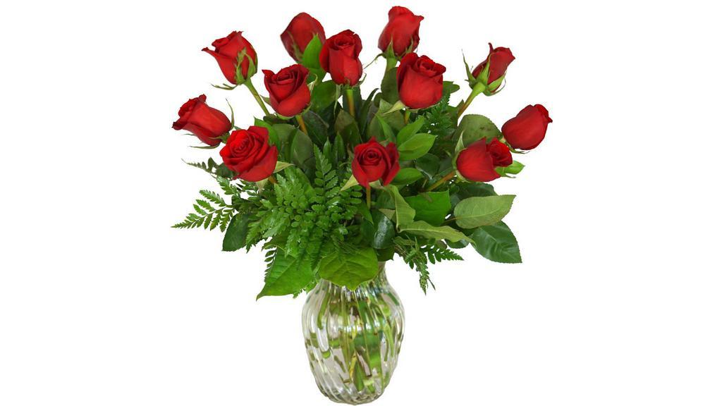 One Dozen Classic Red Roses · One dozen classic red roses, designed in a ginger vase and finished with foliage.