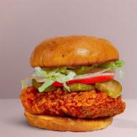 Peno Chicken Sandwich · Seasoned fried vegan chicken patty topped with melted vegan cheese, jalapenos, lettuce, toma...