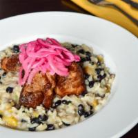 Risotto Di Masitas · Arborio rice with black beans, sweet plantain topped with marinated fries, and caramerlized ...