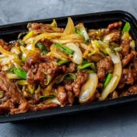 Mongolian Beef · Green onion and bamboo in brown sauce topped with fried rice noodles