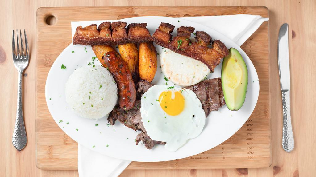 Bandeja Paisa · From Colombia rice, red beans, sweet plantains, corn cake, avocado, pork belly, top round steak, fried egg, and Colombia sausage.