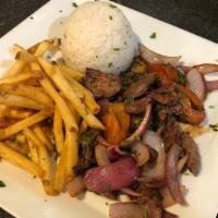 Lomo Saltado · Peruvian stir fry made with beef, onions, tomatoes, cilantro, soy sauce, and garlic. Served ...