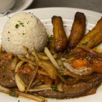 Higado Encebollado · LIVER STEAK TOPPED WITH GRILLED ONIONS AND TOMATOES,SERVED WITH RICE ,SALAD,PLANTAINS AND BE...