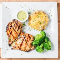 Pollo Con Cilantro Crema · Grilled chicken breast served with mashed potatoes, loaded with roasted corn and melted chee...