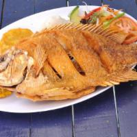 Mojarra · Whole deep fried red fish, served with white rice, green plantains, and salad.
