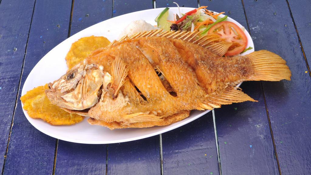 Mojarra · Whole deep fried red fish, served with white rice, green plantains, and salad.