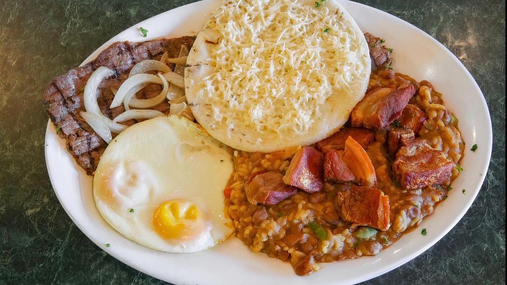 Calentado Paisa · A favorite Colombian breakfast, mix of white rice and red beans, served with two fried eggs, and arepa paisa topped with white cheese.