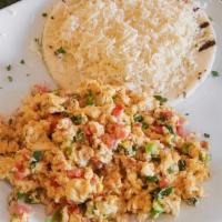 Huevos Perios · Three scrambled eggs with chopped tomatoes and green onions served with arepa and white chee...