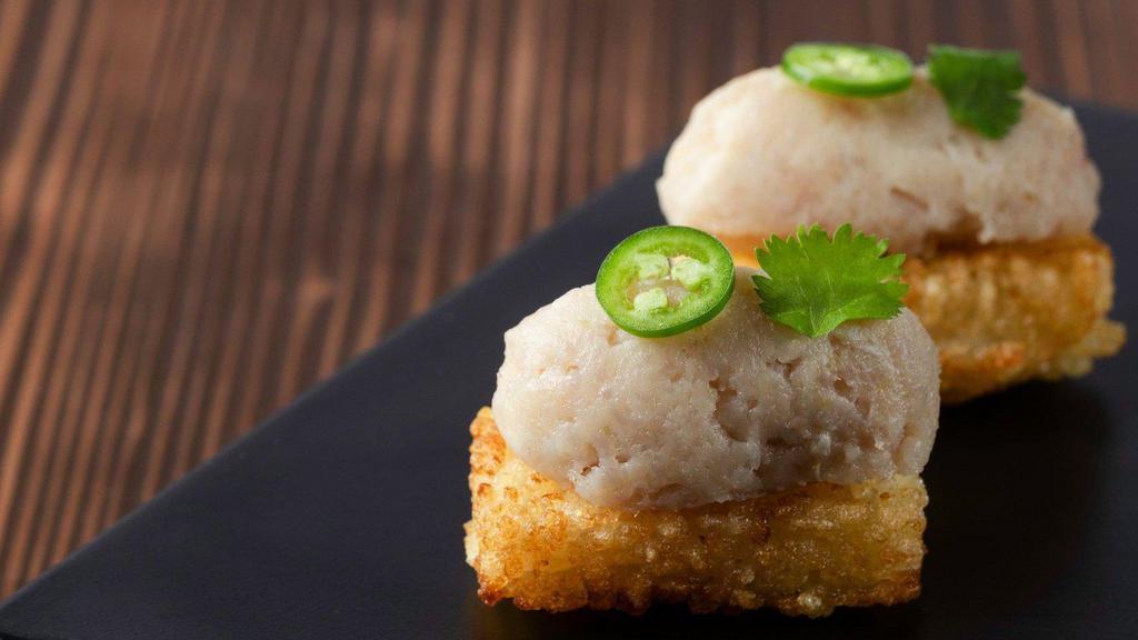Spicy Hamachi Crispy Rice (2 Per Order) · serrano & cilantro. Served room temperature with a side of house soy.