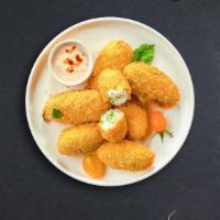 Popping Peno · (Vegetarian) Fresh jalapenos coated in cream cheese and fried until golden brown.