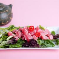 Seared Ahi Tuna Salad · Fresh, sliced raw tuna with a sesame seed crust, seared to perfection and served on a crisp ...