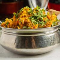 Chicken Biryani · Marinated chicken and saffron-flavored basmati rice with herbs and spices, garnished with ra...