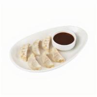 Potstickers · Steamed dumplings filled with chicken, cabbage, shallots, ginger and scallions.