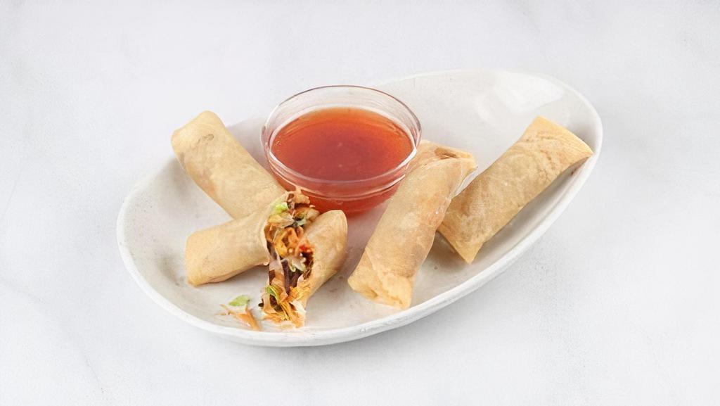 Vegetable Spring Rolls · Crispy vegetable spring rolls filled with green cabbage, ginger, carrots, celery, black mushrooms, onions and glass noodles. Served with a sweet chili sauce.