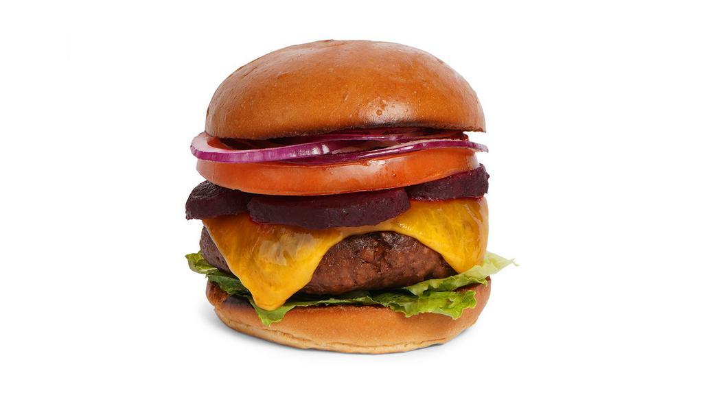 The Australian Burger · Beef patty with crisp bacon, lettuce, tomato, onion, shaved red beets, mayo, and melted cheddar cheese on a fluffy brioche bun.
