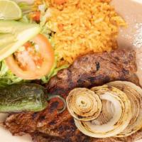 Carne Asada · Grilled skirt steak. Served with rice, beans and salad.