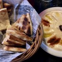 Hummus · Pureed chickpeas with tahini and lemon juice. Served with vegetables and pita bread.