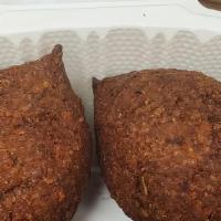 Kibbe Talabalsie · Three pieces. Selected seasoned fine meat ground with wheat stuffed with sauteed onions and ...