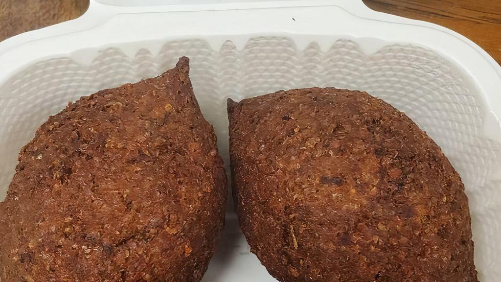 Kibbe Talabalsie · Three pieces. Selected seasoned fine meat ground with wheat stuffed with sauteed onions and ground beef.