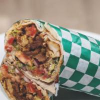 Shawarma · Wrapped in Arabic bread with meat, lettuce, tomato, parsley, gherkins, parsley sauce, and se...