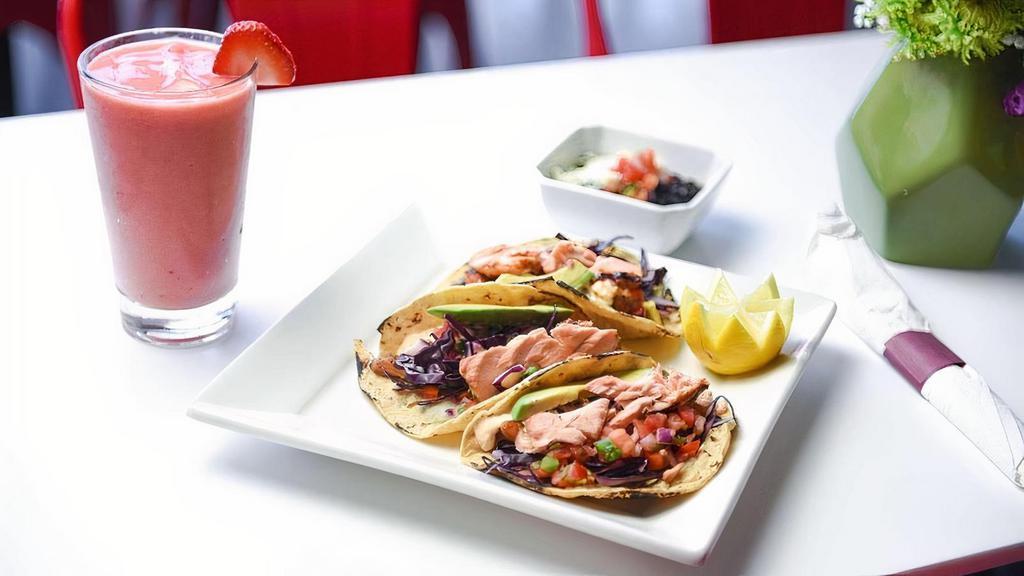 Salmon Tacos · 3 GF corn tortillas, grilled salmon, chipotle, sauce, cabbage, pico de gallo, avocado slices & side of black beans with cheese on top.