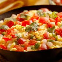 Huevos A La Mexicana · Scrambled eggs, mixed with onions, tomato, and jalapeño pepper, served with rice and corn to...