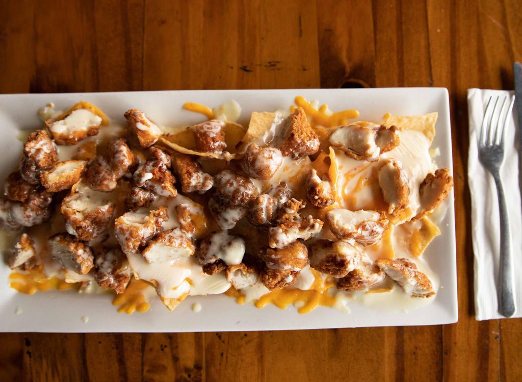 Triple Cheese Chicken Nachos · Perfect for Cheese Lovers! Crispy fried chicken chunks covered in cheese dip and topped with shredded cheese and American Cheese