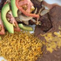 Carne Asada · Grilled thinly sliced marinated steak with grilled onions on top. Served with Mexican rice, ...