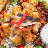 Half Buffalo'S Cobb Salad · Our take on a classic features fresh salad greens layered with bacon, cheddar jack cheese, b...