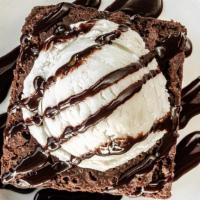 Mesa Brownie · A decadent chocolate brownie topped with a scoop of vanilla ice cream and drizzled with choc...