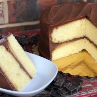 Yellow Layer Cake With Chocolate Fudge Icing · Moist yellow layer cake covered in mc entyre's scratch made, stove cooked chocolate fudge ic...