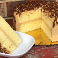 Caramel Turtle Cake · Moist yellow cake layers covered in creamy caramel icing, Topped with strings of McEntyre's ...