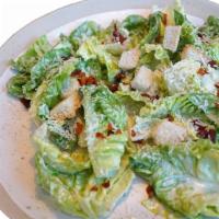 Caesar Salad · Classic Caesar Salad with Romaine lettuce, crunchy croutons, grated cheese, and dressing.