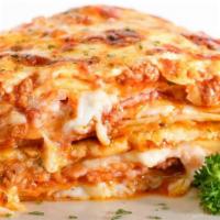 Lasagna · Ground beef, bechamel sauce, mozzarella, ham, and parmesan cheese.