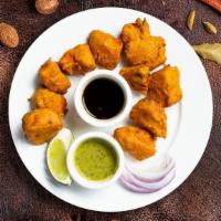 Onion Federal Pakora · Fresh onions dipped in a light batter and fried until golden brown.