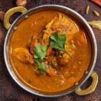 Curry Kinship · Your choice of protein cooked in a tomato-based onion gravy with freshly ground spices.